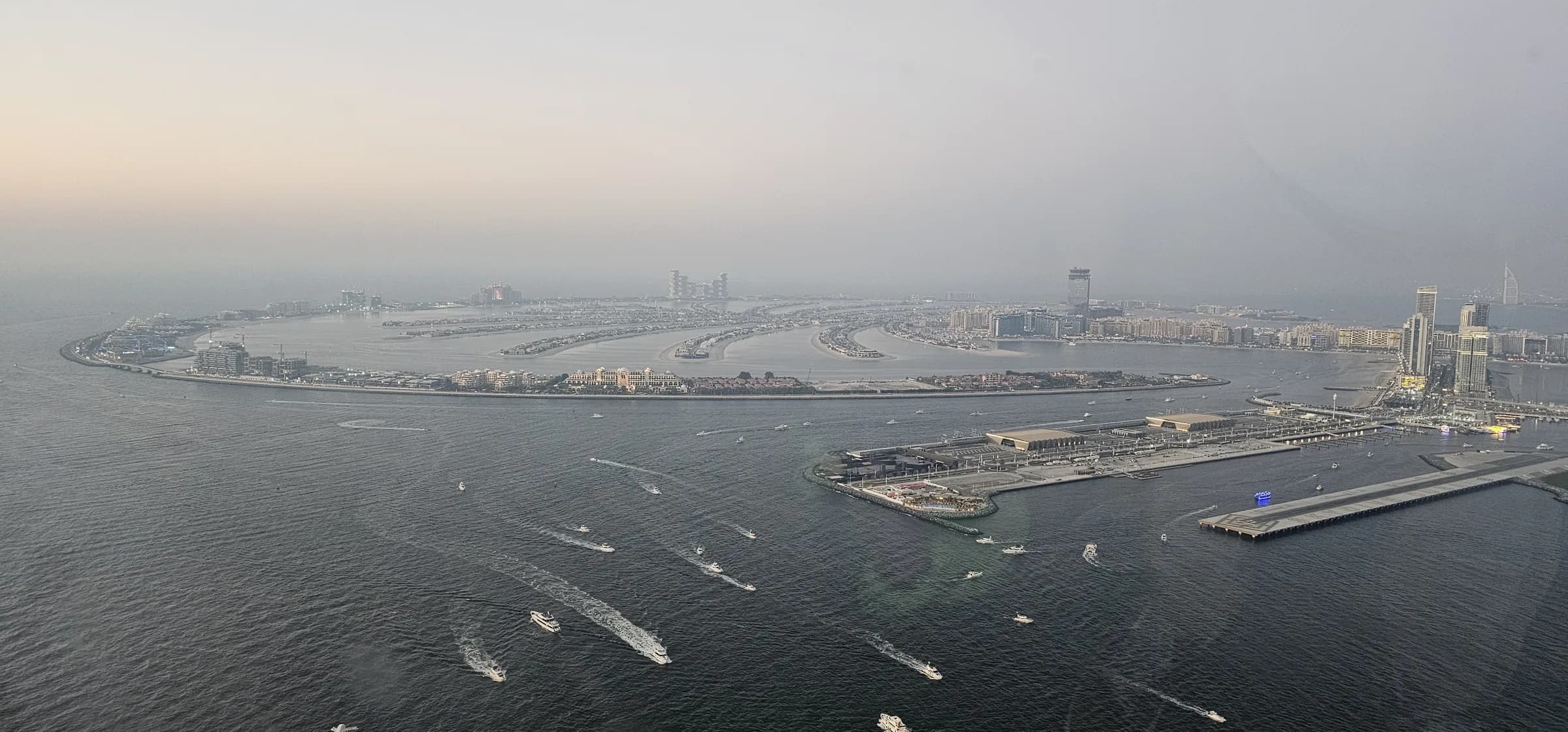 Aerial dusk view of Palm Jumeirah and the Dubai Marina skyline